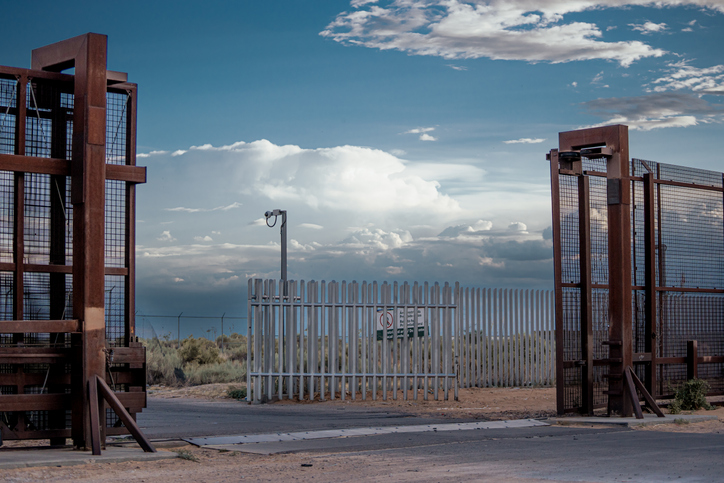 Gate Between United States/Mexico Border Wall Between Sunland Park, New Mexico and Puerto Anapra Chihuahua Mexico Near the Santa Teresa Border Crossing Under a Dramatic Cloudscape Near Dusk