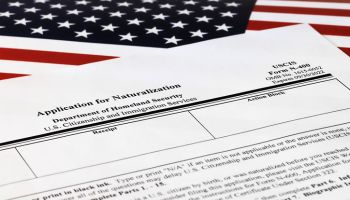 selective focus photo of n-400 form. application for naturalization, on a background of United States flag.