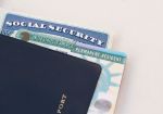 United States passport, social security card and permanent resident (green) card on white background. Immigration concept