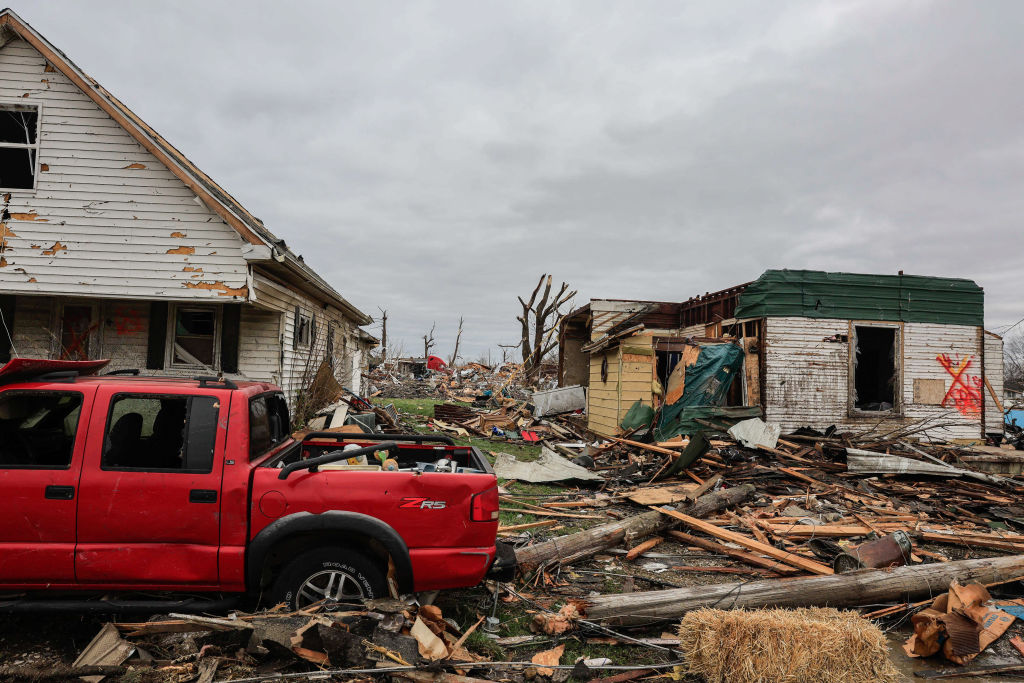 A swath of a residential area is in ruins after a tornado in...