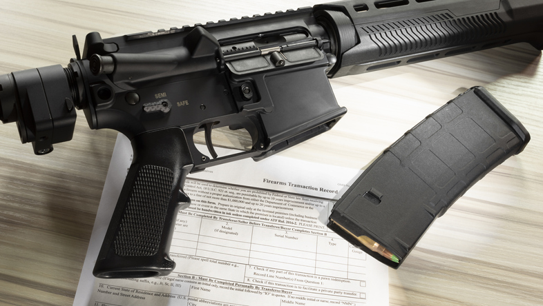 AR-15 and high capacity magazine with purchase form