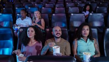 Friends gathered watching movie in movie theater