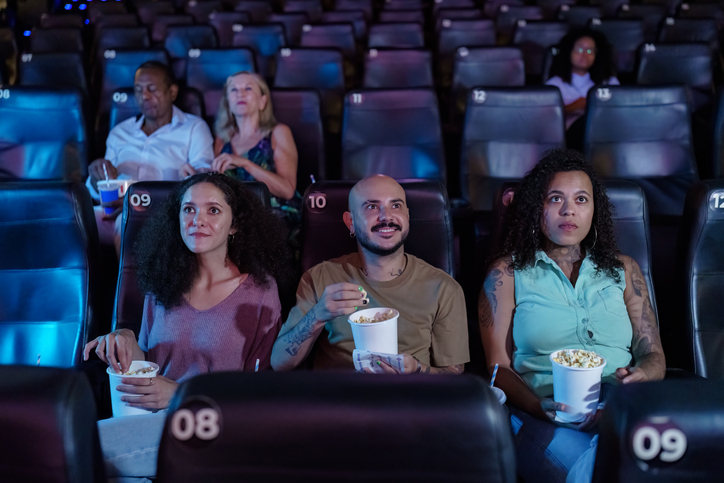 Friends gathered watching movie in movie theater