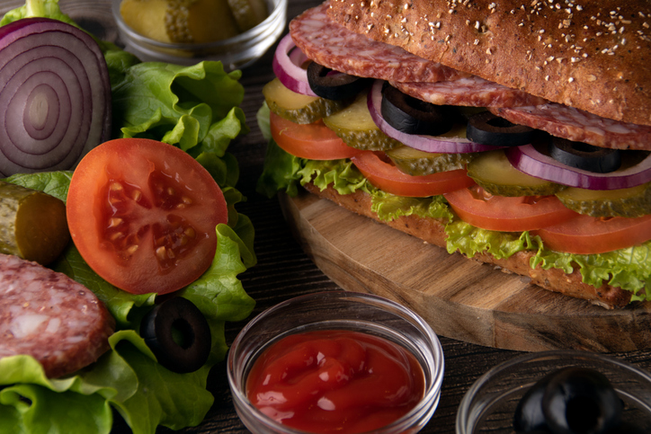 photo of a lot of food to make a salami sandwich