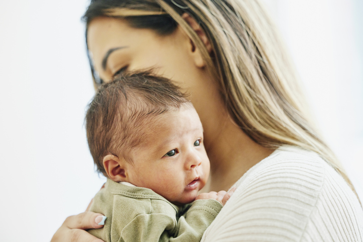 Close up shot mother holding newborn infant during doctors visit