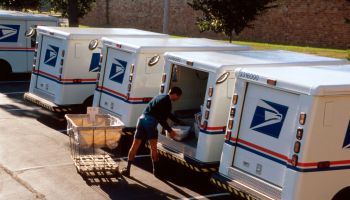 US Post Office, mail carrier loading truck