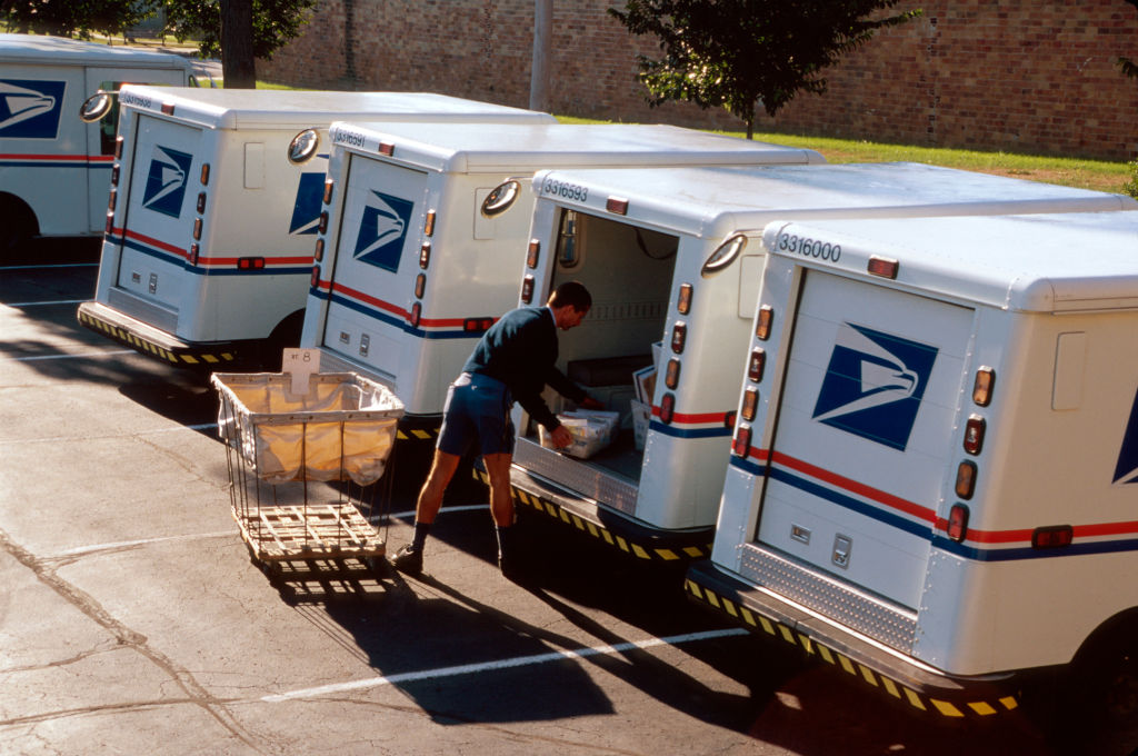 US Post Office, mail carrier loading truck