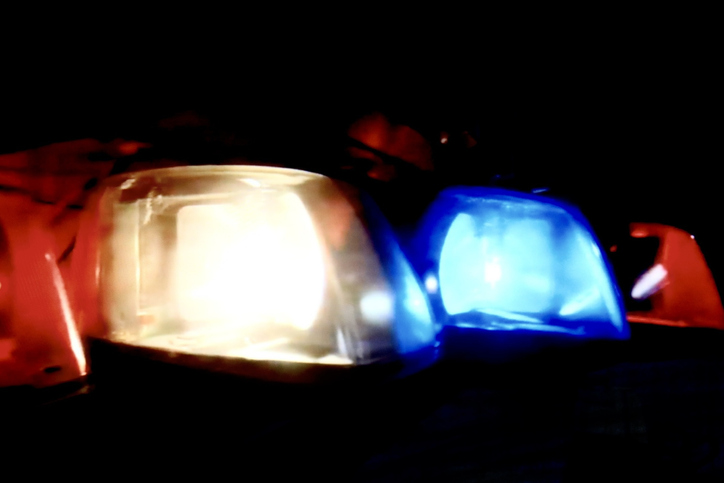 Violence and crime concept with flashing police car lights