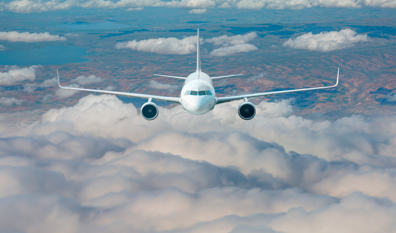 Passenger airplane in the clouds - travel by air transport