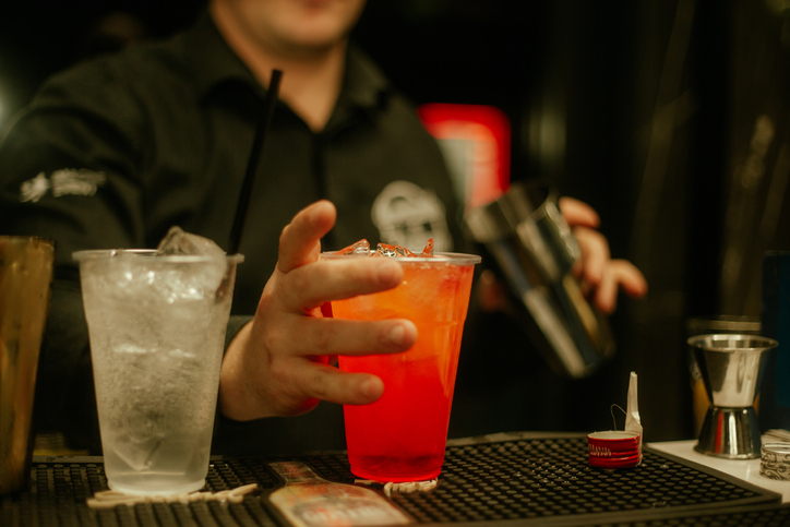 Bartender making cocktail stock photo