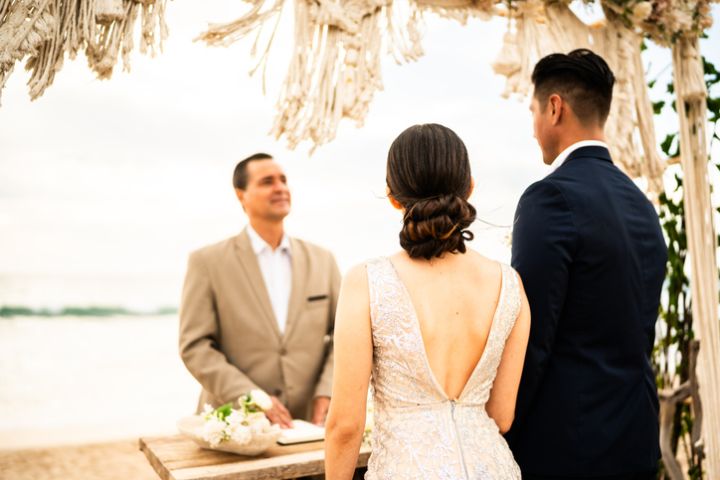 Groom and bride in wedding ceremony on the beach