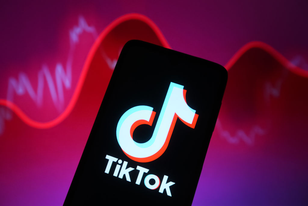 In this photo illustration, a TikTok logo is seen displayed...
