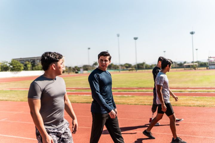 Athletes talking and walking on sports track