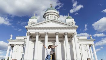 Finland, Helsinki, woman jumping in front of Helsinki Cathedral