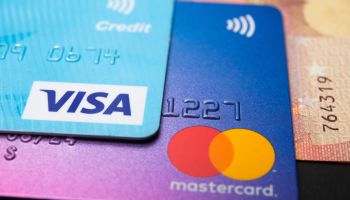 In this photo illustration a Visa credit card and Mastercard...