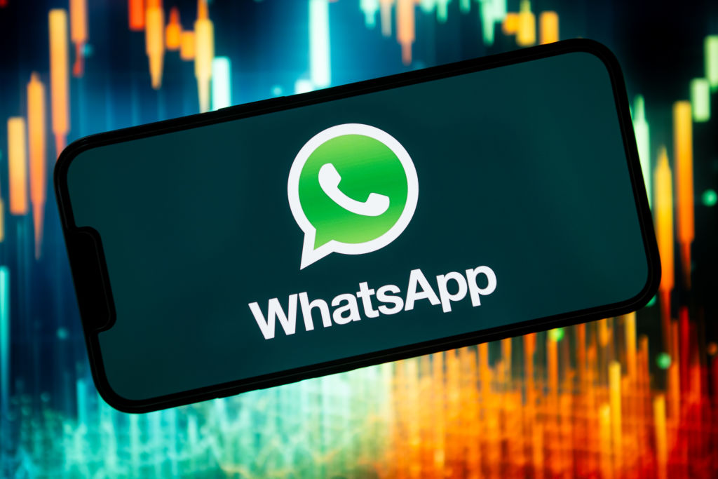 In this photo illustration a WhatsApp logo seen displayed on...