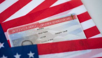 Employment Authorization card on USA Flag surface. Close up view.