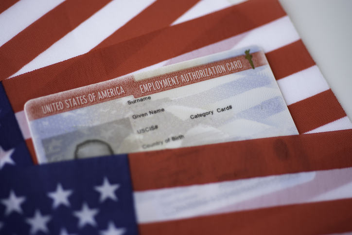 Employment Authorization card on USA Flag surface. Close up view.