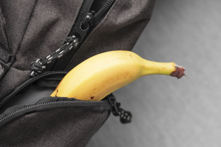 Banana in backpack. School lunch packed. Fruit healthy snack for kid.