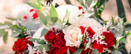 A beautiful bouquet with red and pink blush roses and eucalyptus leaves and greenery