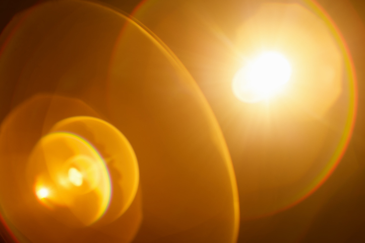Dreamy real lens flare with organic imperfections on dark background