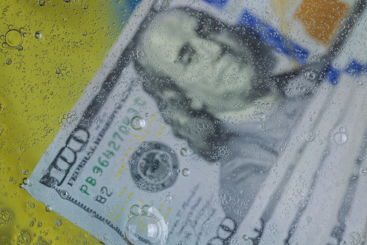 Close up view of abstract texture design of blurred view of hundred dollar bills underwater.