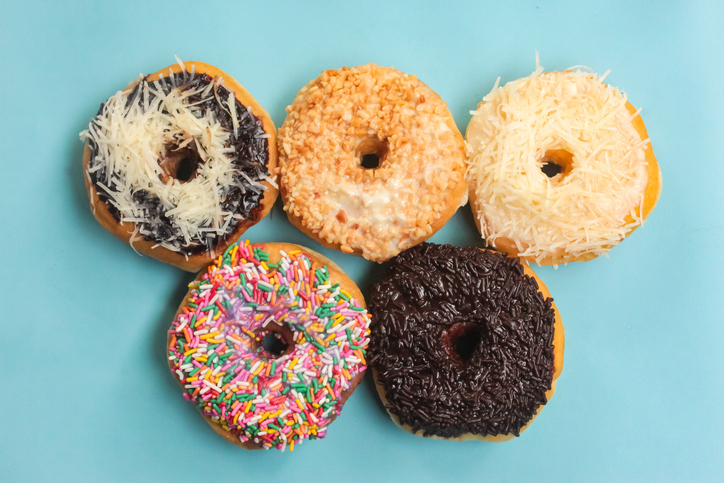 a group of donuts with various flavors, on a blue background