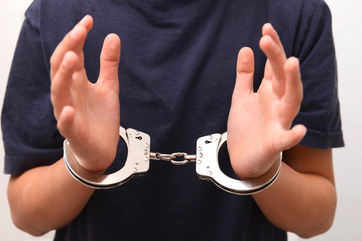 School boy in handcuffs