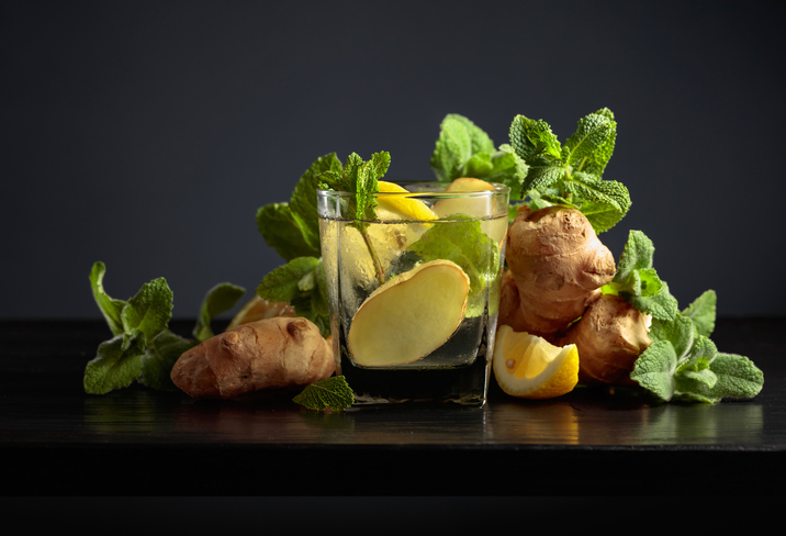 Cold refreshing drink with ice, ginger, lemon, and mint.