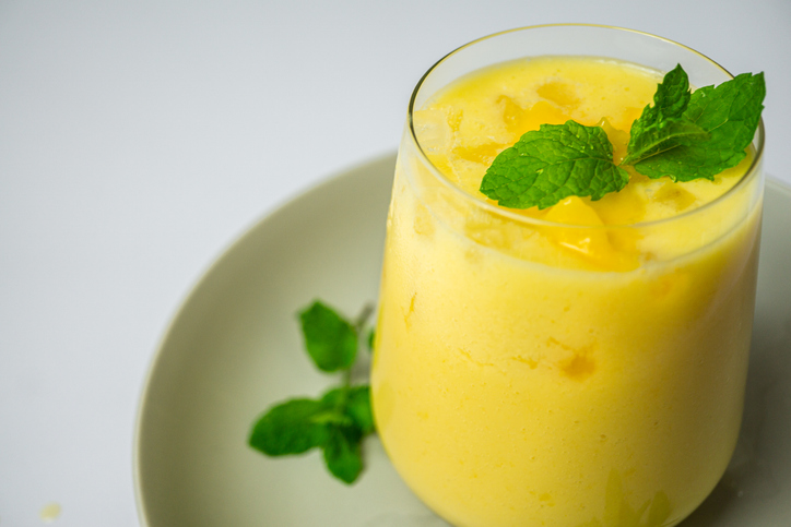 refreshing summer drink decorated with peppermint leaves - mango lassi drink