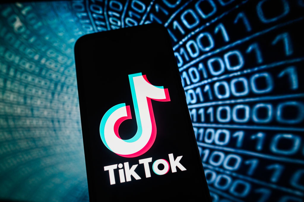 In this photo illustration a TikTok logo is displayed on a...