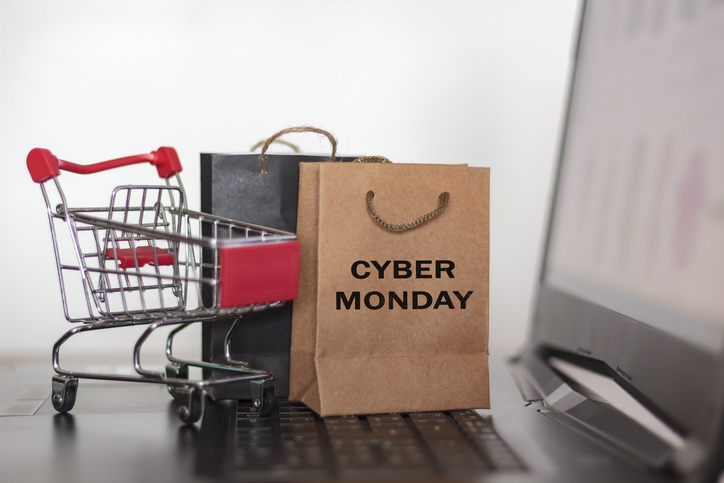 Close-Up Of Shopping Cart And Shopping Bags On Laptop