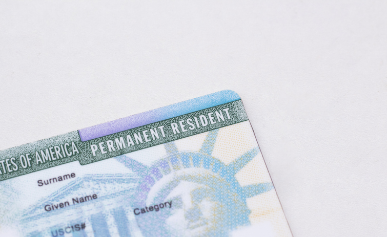 United States passport, social security card and permanent resident (green) card on white background. Immigration concept