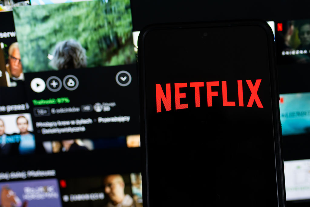 In this photo illustration a Netflix logo seen displayed on...