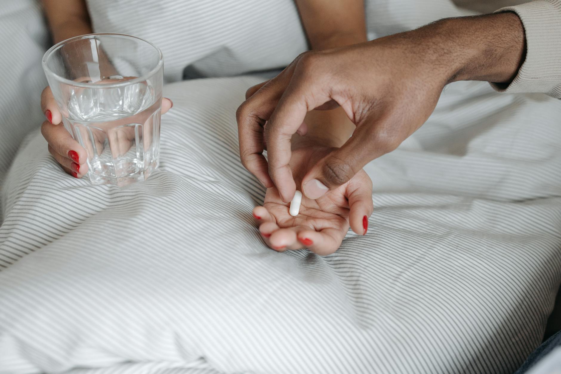 person giving another person a medicine