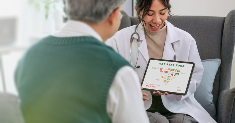 Doctor Explaining new Healthy Eating and Food Pyramid to Senior Patient During Nutrition Counseling