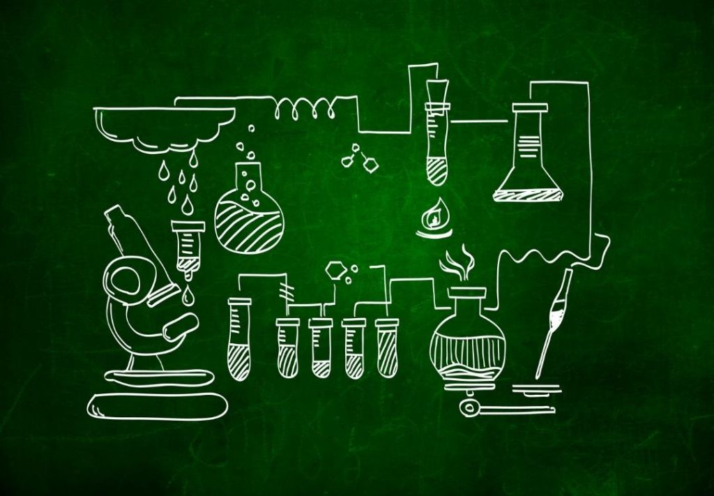 Chalkboard illustration depicting various scientific laboratory equipment and glassware.