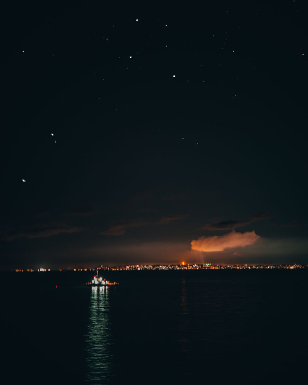 long shot of city lights across river during nighttime