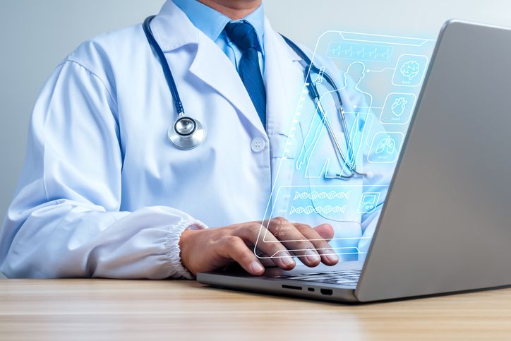 Doctor using laptop with AI medical dashboard and digital patient interface. Healthcare technology, electronic health records, diagnostics, telemedicine, clinical data, and digital healthcare concept.