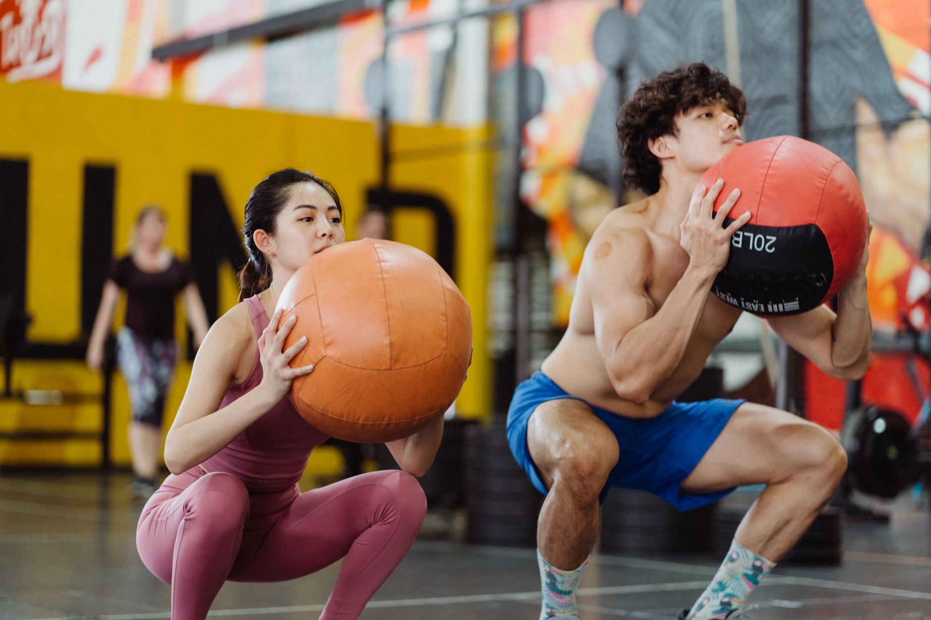a couple working out with medicine balls
