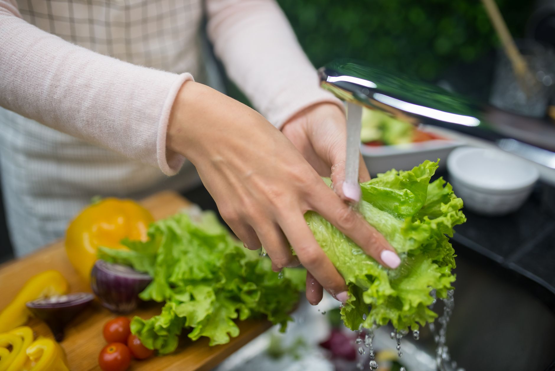 a person washing a lettuce